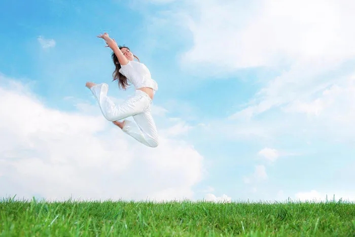 Framed Print : Young woman jumping on meadow Framed Print : Young woman jumping on meadow