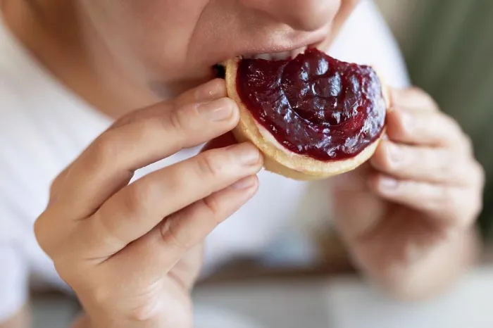 Framed Print : a young woman overeats on sweets while on a diet Framed Print : a young woman overeats on sweets while on a diet