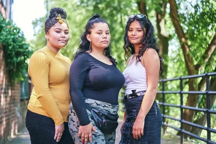 Framed Print : Young woman posing with teenage sisters by park, portrait Framed Print : Young woman posing with teenage sisters by park, portrait