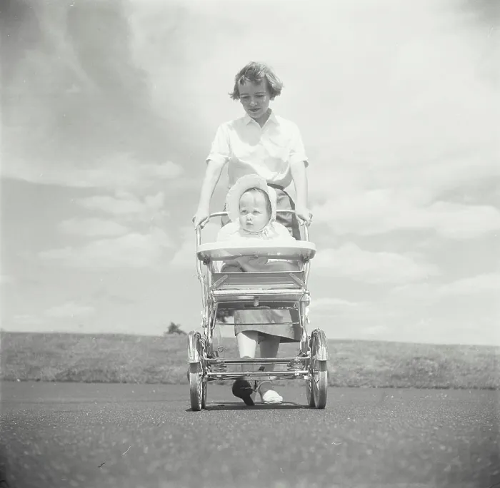 Framed Print : Young woman pushing her baby in a baby stroller Framed Print : Young woman pushing her baby in a baby stroller