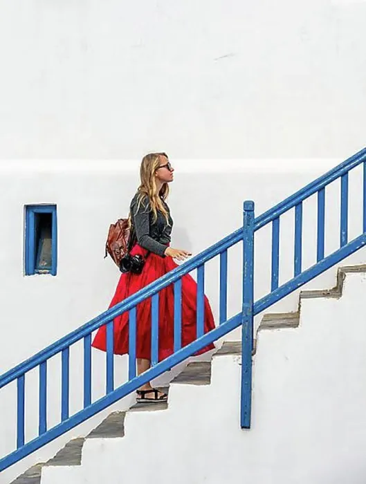 Framed Print : Young woman with red skirt on a staircase with blue banister Framed Print : Young woman with red skirt on a staircase with blue banister