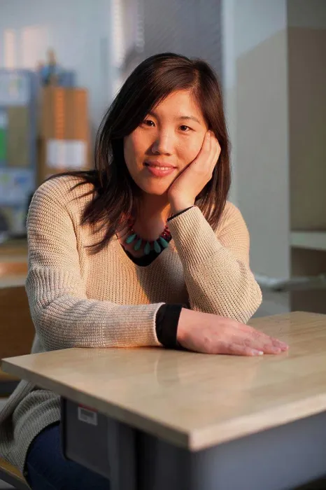 Framed Print : A young woman sits at a desk in a classroom, beijing, china