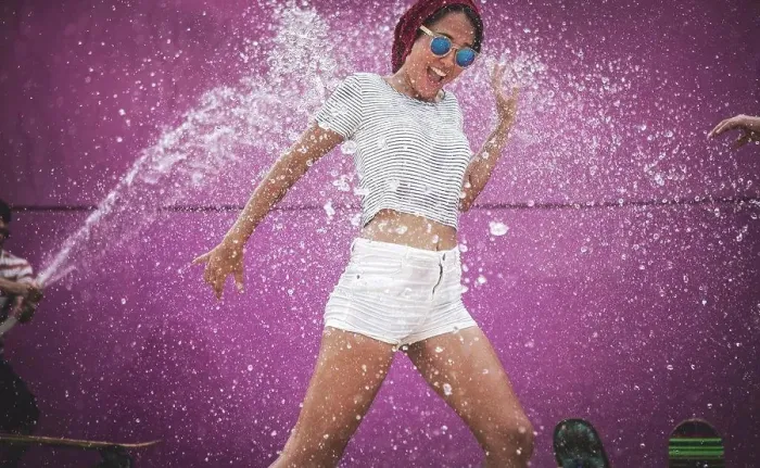 Framed Print : A young woman being sprayed with water Framed Print : A young woman being sprayed with water
