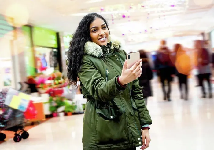 Framed Print : Young woman taking selfie in shopping mall Framed Print : Young woman taking selfie in shopping mall
