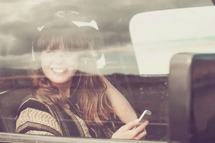 Framed Print : Young woman travelling in car listening music Framed Print : Young woman travelling in car listening music