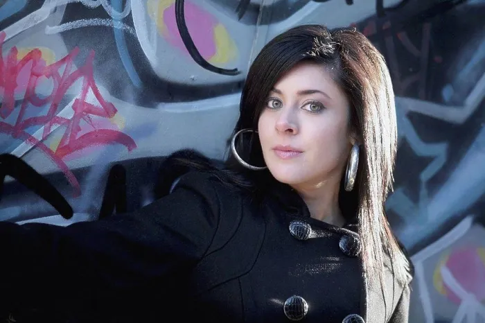 Framed Print : a young woman against a wall with graffiti Framed Print : a young woman against a wall with graffiti