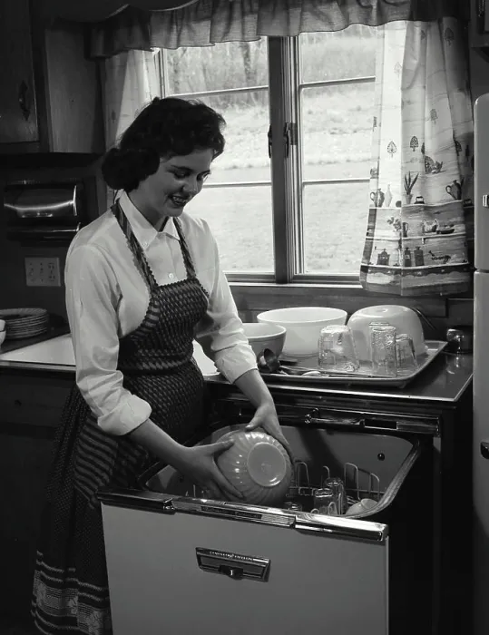 Framed Print : Young woman working in a kitchen Framed Print : Young woman working in a kitchen