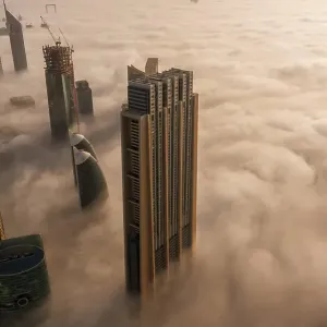 Aerial view of buildings surrounded by clouds Dubai, United Arab Emirates Aerial view of buildings surrounded by clouds Dubai, United Arab Emirates
