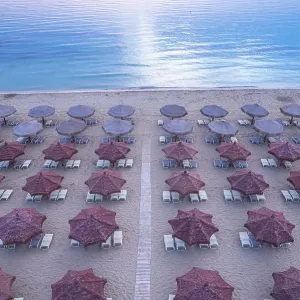 Aerial view of large group of tidy beach umbrellas facing the Mediterranean Sea, Italy, Europe Aerial view of large group of tidy beach umbrellas facing the Mediterranean Sea, Italy, Europe