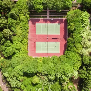 Aerial view of tennis courts in the middle of dense vegetation in Dubai, U.A.E Aerial view of tennis courts in the middle of dense vegetation in Dubai, U.A.E