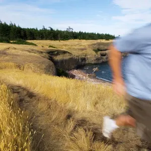 Blurred runner on trail, Hornby Island at Helliwell Park, Gulf Islands British Columbia, Canada Blurred runner on trail, Hornby Island at Helliwell Park, Gulf Islands British Columbia, Canada