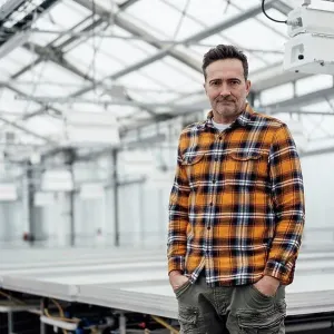 Businessman standing with hands in pockets at greenhouse Businessman standing with hands in pockets at greenhouse