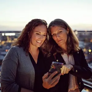 Businesswomen taking selfie on smart phone while standing on terrace after work Businesswomen taking selfie on smart phone while standing on terrace after work