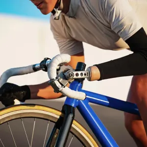 Close-up of athletic woman with prosthetic arm riding bicycle Close-up of athletic woman with prosthetic arm riding bicycle