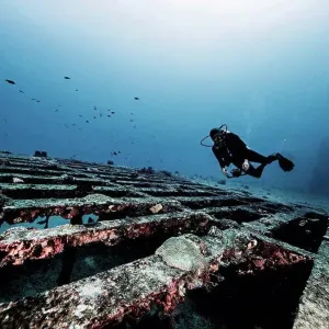 Diver exploring shipwreck, underwater view, Cancun, Mexico Diver exploring shipwreck, underwater view, Cancun, Mexico