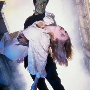 Frankenstein carrying a young woman
