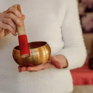 Hands of retired senior woman holding singing bowl Hands of retired senior woman holding singing bowl