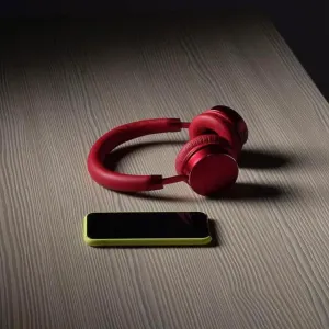 Headphones and smart phone on table Headphones and smart phone on table