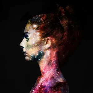 Intergalactic beauty. Profile of a young woman with the galaxy overlaid on her face Intergalactic beauty. Profile of a young woman with the galaxy overlaid on her face