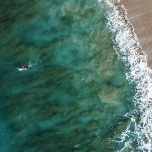 Male surfer paddles on board on Oahu, Hawaii Male surfer paddles on board on Oahu, Hawaii