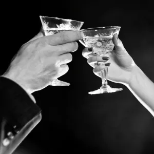 Man's hand and woman's hand toasting with Martini Man's hand and woman's hand toasting with Martini