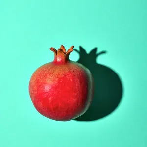 Pomegranate on turquoise background