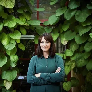 Portrait of confident female architect standing against creeper plants in backyard Portrait of confident female architect standing against creeper plants in backyard