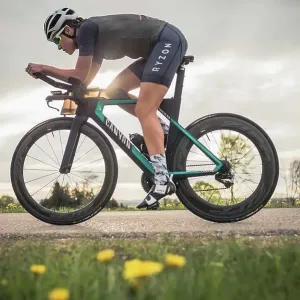 Professional triathlete on her road bike, time trial bike round, Auerberg, Allgäu, Bavaria, Germany Professional triathlete on her road bike, time trial bike round, Auerberg, Allgäu, Bavaria, Germany