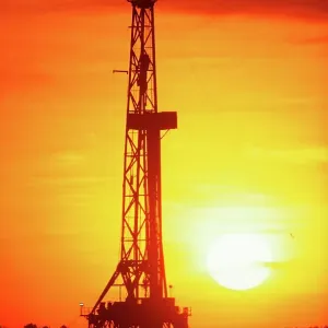 Silhouette of an oil drilling rig at sunset Silhouette of an oil drilling rig at sunset