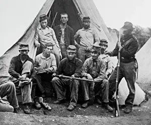 Oldtime Prints: 1860s GROUP OF NINE UNION SOLDIERS SEATED IN FRONT OF TENT HOLDING RIFLES LOOKING AT CAMERA