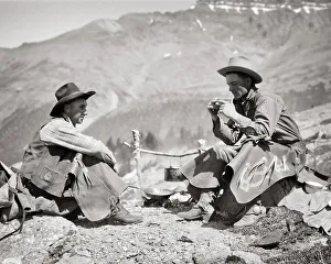 Wide Angle Prints: 1920s 1930s TWO MEN WESTERN COWBOYS SITTING BY CAMPFIRE DRINKING COFFEE TALKING SUMMIT OF PASS NEAR BOW LAKE ALBERTA