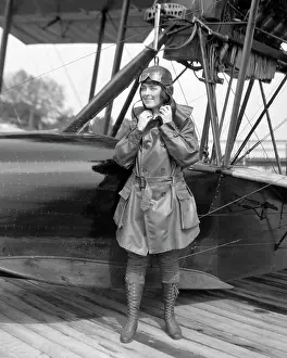 Oldtime Prints: 1920s FEMALE AVIATOR AVIATRIX LEATHER COAT CAP WITH GOGGLES AND LACE UP BOOTS PREPARING TO BOARD SEAPLANE