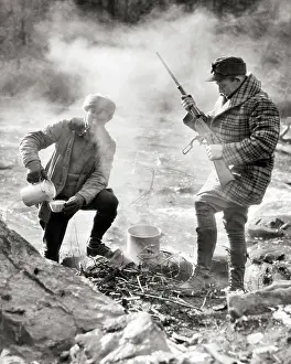 Macho Prints: 1920s TWO HUNTERS STANDING CAMPED BY STREAM ONE MAKING COFFEE OVER CAMPFIRE ONE CHECKING LEVER ACTION RIFLE NEW