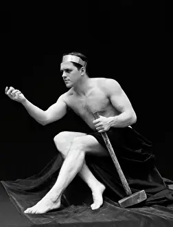 Story Prints: 1920S Man Semi Nude Classical Pose Sitting Holds Long Armed Hammer Wearing Headband Retro Vintage