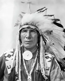 Mid Adultman Prints: 1920s PORTRAIT NATIVE AMERICAN INDIAN MAN CHIEF SITTING EAGLE IN FULL HEADDRESS STONEY TRIBE OF BANFF ALBERTA CANADA