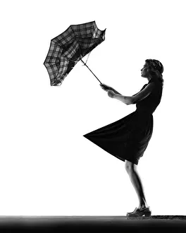 Anonymous Prints: 1930s 1940s ANONYMOUS SILHOUETTE OF TEENAGE GIRL WITH UMBRELLA TURNED INSIDE OUT IN THE WIND