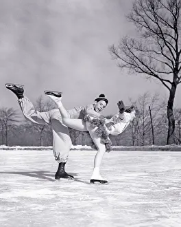 1930s 1940s COUPLE MAN AND WOMAN PAIR FIGURE SKATERS ON OUTDOOR ICE RINK WEARING COSTUMES MAN LOOKING AT CAMERA - w148 HAR001 HARS YOUNG ADULT BALANCE TEAMWORK COMPETITION ATHLETE COSTUMES JOY LIFESTYLE SATISFACTION FEMALES ATHLETICS COPY SPACE