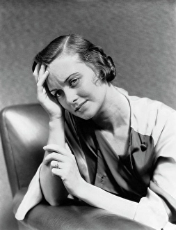 Ponder Prints: 1930S 1940S Woman Sitting In Chair Worried Sad Expression One Hand Up To Her Forehead