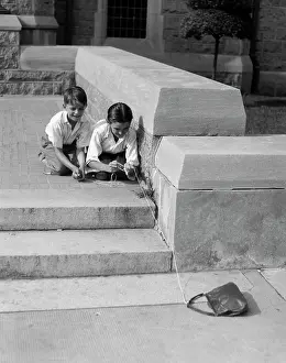 Mischievous Prints: 1930S Two Boys Playing Trick With String Tied To Lost Purse