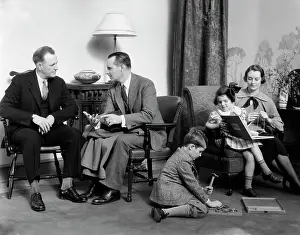 Talks Prints: 1930S Family In Living Room Mother Knits Daughter On Her Lap With Book Son On Floor With Hammer