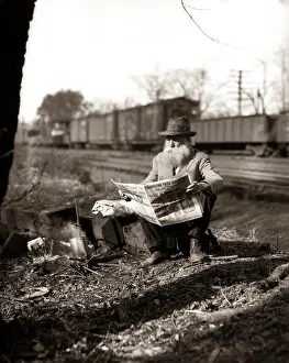 Dreams Prints: 1930S Hobo Sitting By Railroad Track Reading Newspaper During Great Depression
