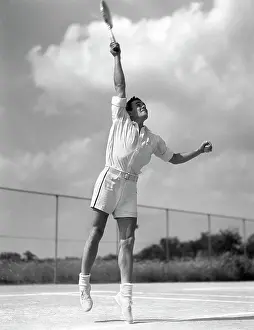 Serve Prints: 1930S Man In Mid Serve Playing Tennis Jumping Swinging Tennis Racket To Hit Ball