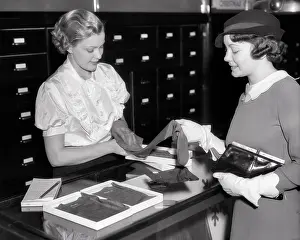 Gloves Prints: 1930s SALES CLERK HELPING SHOPPER WITH A SELECTION OF HOSIERY SILK STOCKINGS