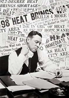 Dangerous Prints: 1930s SWEATING MAN SITTING AT DESK READING PAPERS USING HANDKERCHIEF WIPING HIS NECK BACKGROUND OF HEAT WAVE NEWSPAPER