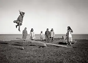Indians Prints: 1940s 1950s ALASKAN ESKIMO CHILDREN AND TEENS PLAYING A GAME OF JUMPBOARD A KIND OF SEESAW GAME ARCTIC KOTZEBUE ALASKA