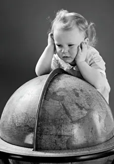 Global Prints: 1940S Baby Looking At Leaning On Globe Of Earth