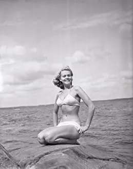 Bikini Prints: 1940s bikinifashion. A swedish young woman in a white bikini on a summer's day