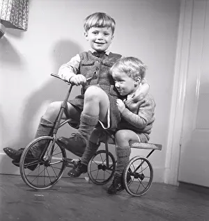 Bicycle Prints: 1940s children. Two boys are playing on a tricycle