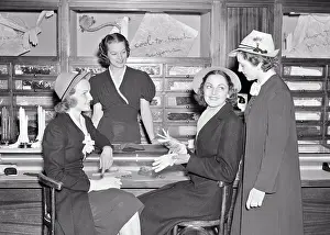 Customer Prints: 1940s GROUP OF FOUR WOMEN AT GLOVE COUNTER OF A DEPARTMENT STORE TALKING SMILING SELECTING A PAIR OF GLOVES