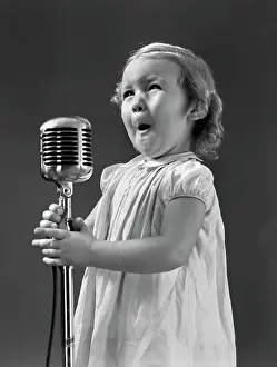 Speak Prints: 1940S Little Girl Making Face Singing Into Microphone